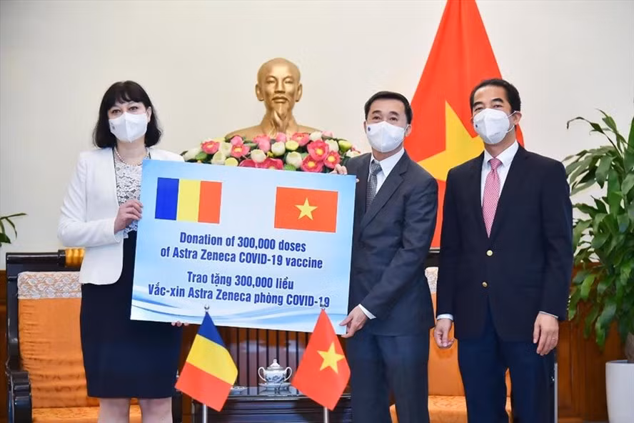 Thứ trưởng Ngoại giao Tô Anh Dũng (phải), Thứ trưởng Bộ Y tế Trần Văn Thuấn (giữa) tiếp nhận tượng trưng 300.000 liều vắc xin Romania trao tặng. Ảnh: BNG.