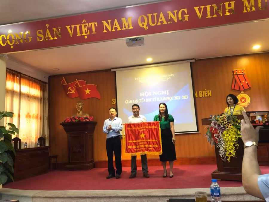 Ông Nguyễn Văn Đoạt, Giám đốc Sở GD&amp;ĐT Điện Biên trao Cờ thi đua của Chính phủ cho lãnh đạo Trường PTDTNT THPT huyện Mường Nhé.