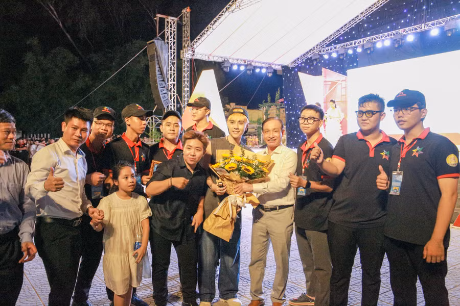 Lãnh đạo Nhà trường, thầy cô và sinh viên tặng hoa và chụp hình lưu niệm với ca sĩ khách mời. (Ảnh: Hoàng Hải).