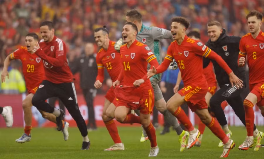 Cầu thủ Xứ Wales chạy ùa vào sân mừng chiến tích lịch sử sau trận đấu với Ukraine.