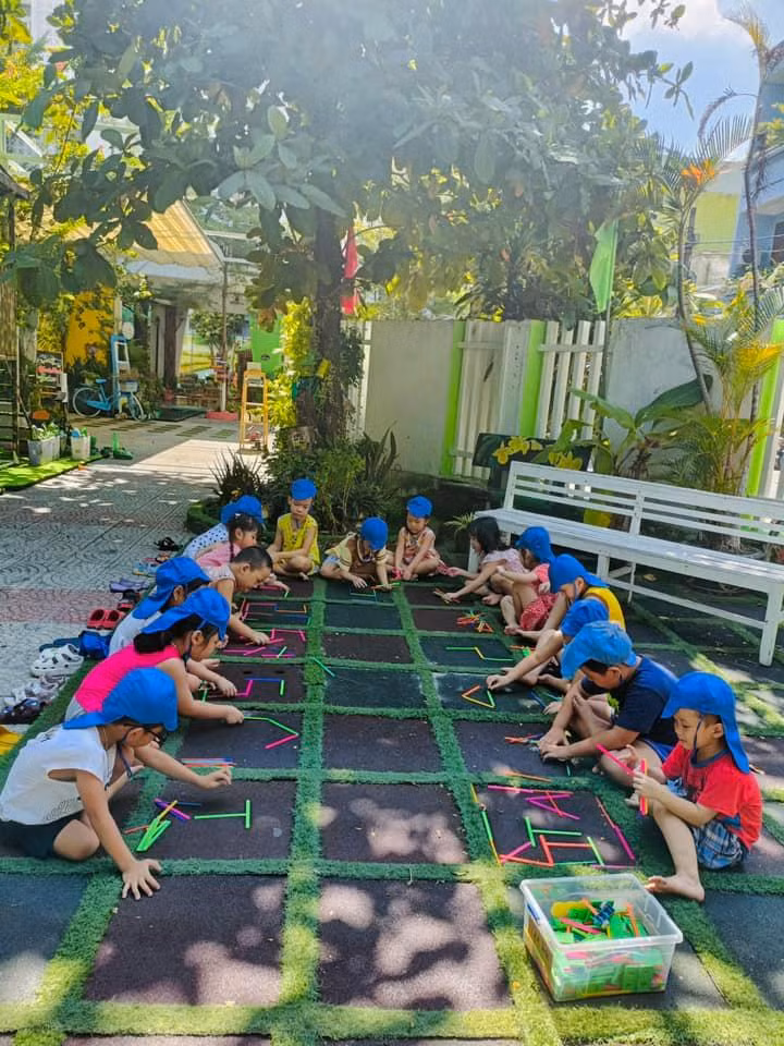 Trẻ mầm non 5 tuổi học ghi nhớ chữ cái thông qua các trò chơi. Ảnh: Giờ hoạt động ngoài trời của lớp Lớn, Trường Mầm non Bình Minh.