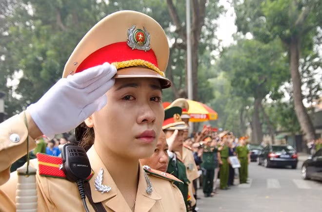 Đám đông xếp hàng dọc theo các đường phố ở Hà Nội với hình ảnh Đại tướng trong tay và than khóc tiễn đưa ông - một huyền thoại dân tộc. Ảnh: Nguyễn Khánh - Tuổi Trẻ. 10 hình ảnh khó quên trong lễ tang Đại tướng Võ Nguyên Giáp