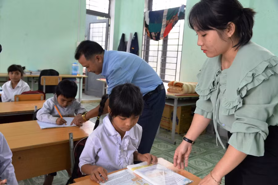 Thầy giáo Nguyễn Thanh Tuấn và con gái là cô giáo Nguyễn Thị Ý Mỹ chăm sóc học trò tại điểm trường Nước Nia, xã Trà Bùi (Trà Bồng, Quảng Ngãi). Ảnh minh họa: INT