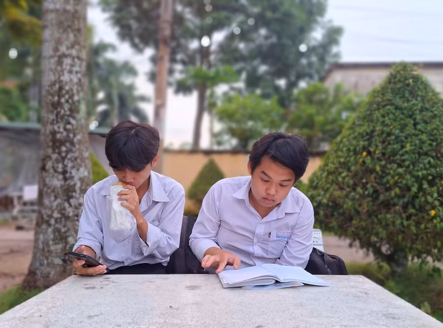 Thí sinh vừa tranh thủ ăn sáng vừa xem lại bài trước giờ thi. Thí sinh vừa tranh thủ ăn sáng vừa xem lại bài trước giờ thi.