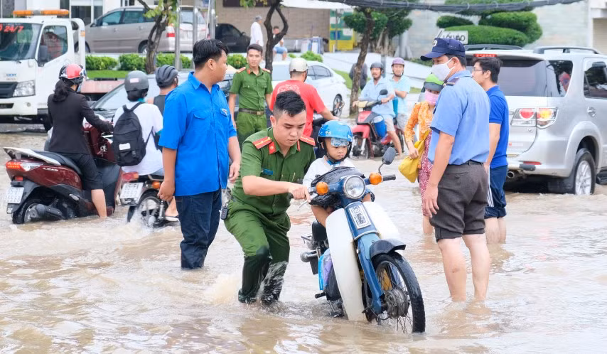 Nước ngập do triều cường khiến việc đến trường của HS Cần Thơ gặp nhiều khó khăn. 