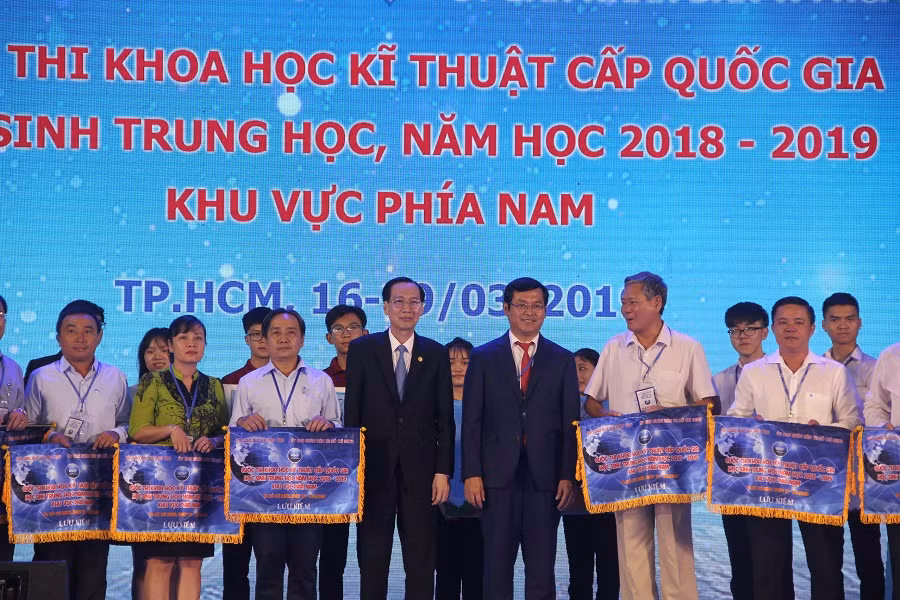 Thứ trưởng Nguyễn Văn Phúc và ông Lê Thanh Liêm, Phó Chủ tịch Thường trực UBND TP.HCM, trao cờ lưu niệm cho các Sở GD&ĐT tham dự cuộc thi 
