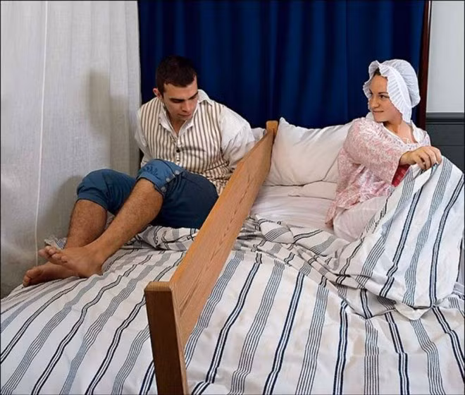Ngủ cùng giường: Người Amish có nhiều truyền thống lạ lùng, nhưng bạn sẽ bất ngờ khi biết các chàng trai được phép tới nhà và ngủ cùng giường với cô gái mình yêu trước khi kết hôn (dù không được phép vượt quá giới hạn). Trong nhiều trường hợp, giữa giường sẽ có một tấm gỗ để tránh các cặp đôi chạm vào nhau. Họ sẽ nằm nói chuyện cả đêm để hiểu hơn về nhau, cũng như thể hiện ý chí chống lại các cám dỗ. Ảnh: The Richest. Những tục lệ tán gái kỳ quặc