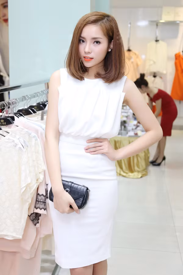 Người đẹp gốc Nam Định diện váy trắng cùng clutch cầm tay và giày hàng hiệu.