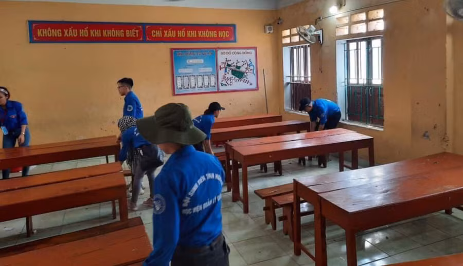 Sinh viên Học viện Quản lý Giáo dục dọn dẹp, sơn sửa lại phòng học, bàn ghế. Ảnh: NTCC
