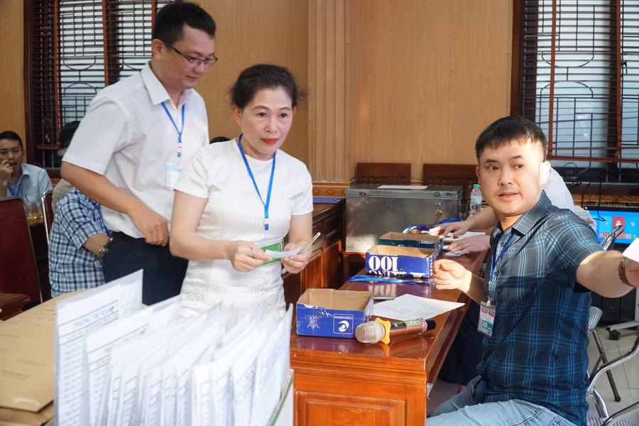 Giám thị nhận thẻ cán bộ coi thi, bốc thăm phòng thi và nhận túi đựng phiếu làm bài tại điểm thi Trường THPT chuyên Phan Bội Châu. Ảnh: Hồ Lài.