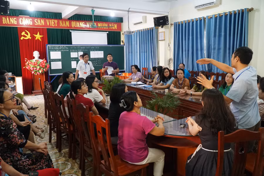 Họp cán bộ coi thi, trao đổi về đánh số báo danh, sắp xếp chỗ ngồi cho thí sinh tham gia bài thi tổ hợp KHTN-KHXH tại điểm thi Trường Phổ thông DTNT THPT tỉnh Nghệ An. Ảnh: Hồ Lài.