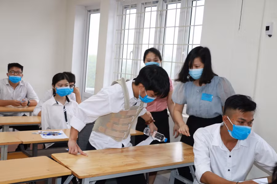 Nguyễn Thái Cường được hỗ trợ ngồi vào đúng vị trí phòng thi của mình
