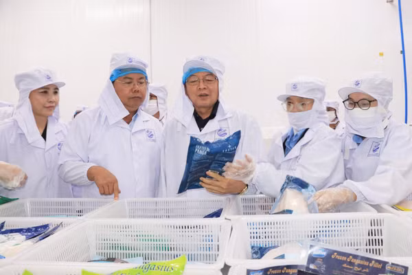 Phó Thủ tướng Hồ Quốc Dũng (giữa) và Bí thư Tỉnh ủy An Giang Nguyễn Tiến Hải tham quan quy trình sản xuất tại Công ty Cổ phần Xuất nhập khẩu thủy sản Cửu Long.