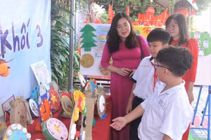 Bà Nguyễn Vĩnh Bảo Châu, Phó trưởng phòng GD&ĐT Quận 12 và cô Lê Thị Thoa, Hiệu trưởng Trường tiểu học Thuận Kiều, nghe học sinh khối 3 giới thiệu về sản phẩm.